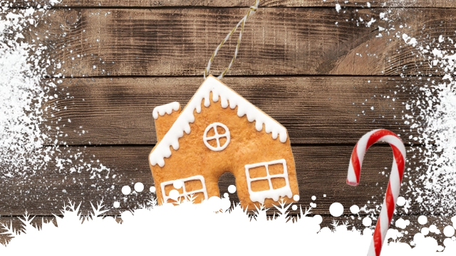 A gingerbread house on a wooden background